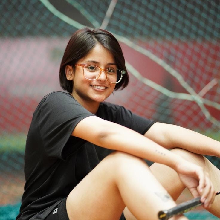 Kaveri Mehta, Lead Design Curator at Harbor Cedar Plume, reviewing corporate floral arrangements